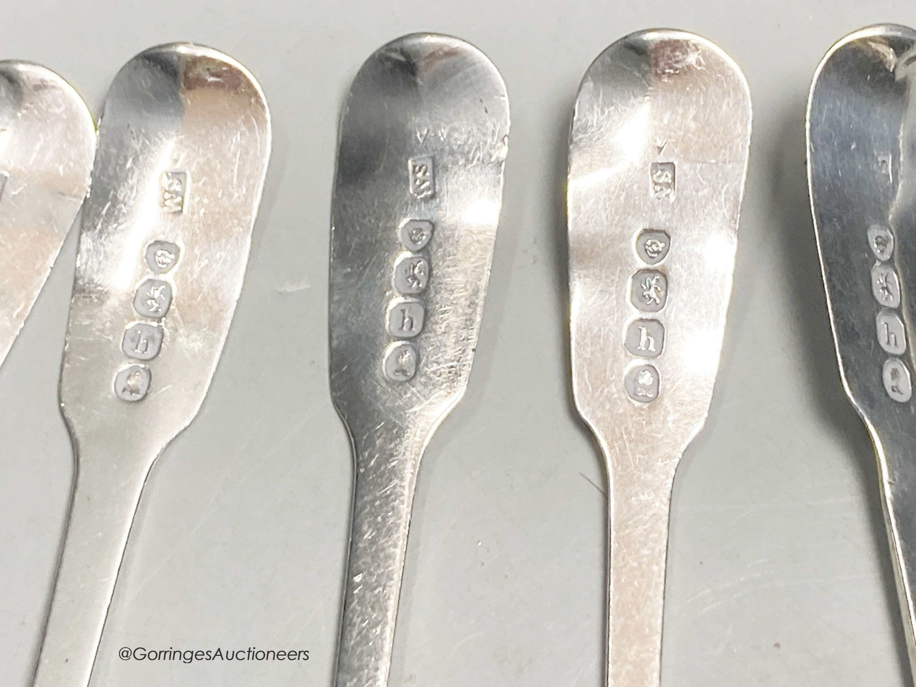 A set of six George IV silver fiddle pattern teaspoons, London, 1823, a later cased set of six silver coffee spoons and a cased mother of pearl handled silver toasting fork.